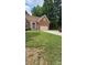 Charming brick home with an attached two car garage and a well manicured green lawn at 8731 Sheltonham Way, Charlotte, NC 28216