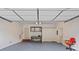 Spacious garage featuring a workbench, shelving, and ample storage space at 8731 Sheltonham Way, Charlotte, NC 28216