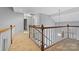 Second floor hallway with white wood trim and view of the staircase at 8731 Sheltonham Way, Charlotte, NC 28216