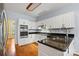 Kitchen with stainless steel appliances, granite counters and white cabinets at 8731 Sheltonham Way, Charlotte, NC 28216
