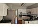 Well-lit kitchen featuring white cabinetry, stainless steel appliances, and granite countertops at 8731 Sheltonham Way, Charlotte, NC 28216