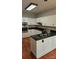 Kitchen with sleek white cabinetry, black countertops, and stainless steel appliances at 8731 Sheltonham Way, Charlotte, NC 28216
