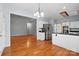 Open kitchen with stainless steel refrigerator and hardwood floors at 8731 Sheltonham Way, Charlotte, NC 28216