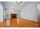 Bright living room boasting hardwood floors, a brick fireplace, and ample natural light from windows at 8731 Sheltonham Way, Charlotte, NC 28216