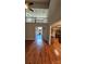 Open floor plan with wood floors, bright natural light and an open staircase at 8731 Sheltonham Way, Charlotte, NC 28216