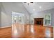 Spacious living room features a fireplace, hardwood floors, and multiple windows at 8731 Sheltonham Way, Charlotte, NC 28216