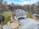 Aerial view of a home featuring an attached two-car garage and a spacious gravel driveway at 10000 Blossom Dr, Concord, NC 28025