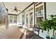 Charming covered back porch features a ceiling fan and comfortable seating, perfect for relaxing outdoors at 10000 Blossom Dr, Concord, NC 28025