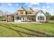 Expansive backyard view showcasing a well-maintained lawn, large home, and a charming outdoor patio at 10000 Blossom Dr, Concord, NC 28025
