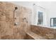 Modern bathroom with tiled shower, bench seating, and bright window at 10000 Blossom Dr, Concord, NC 28025