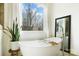 Modern bathroom featuring a freestanding tub, large window and minimalist design at 10000 Blossom Dr, Concord, NC 28025