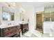 Luxurious bathroom with dual vanities, stone-tiled shower, and modern fixtures at 10000 Blossom Dr, Concord, NC 28025