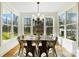 Bright dining area with natural light, stylish chandelier, and a rustic wooden table at 10000 Blossom Dr, Concord, NC 28025