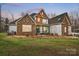 Charming two-story home with stone accents, a covered porch, and a well-manicured lawn at 10000 Blossom Dr, Concord, NC 28025