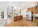Open-concept kitchen with stainless steel appliances, granite countertops, and hardwood floors at 10000 Blossom Dr, Concord, NC 28025