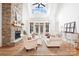 Bright living room with a stone fireplace, tall windows, and comfortable seating at 10000 Blossom Dr, Concord, NC 28025