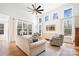 Sun-filled living room featuring high ceilings, large windows, and comfortable seating at 10000 Blossom Dr, Concord, NC 28025