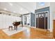An elegant living room featuring a grand piano, high ceilings, and built-in shelving at 10000 Blossom Dr, Concord, NC 28025