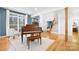 A spacious living room featuring hardwood floors, a grand piano, and an open staircase at 10000 Blossom Dr, Concord, NC 28025