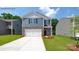 Charming two-story home featuring a stone-accented facade, attached two-car garage, and manicured lawn at 1014 Hostler Ln, York, SC 29745