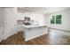 Modern kitchen featuring white cabinets, stainless steel appliances, a center island, and hardwood floors at 1014 Hostler Ln, York, SC 29745