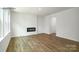 Bright living room featuring a modern fireplace, hardwood floors, and neutral walls at 1014 Hostler Ln, York, SC 29745