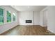 Spacious living room with a modern fireplace, hardwood floors, and bright natural light from large windows at 1014 Hostler Ln, York, SC 29745