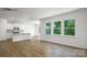 Bright and airy living room with hardwood floors, large windows, and an open layout to the kitchen at 1014 Hostler Ln, York, SC 29745