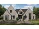Magnificent brick home featuring a well-manicured lawn and beautifully landscaped flower beds at 102 Pecan Cove Ln, Weddington, NC 28104