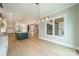 Chic kitchen with a dark island, open layout and fireplace view creating seamless living between rooms at 102 Pecan Cove Ln, Weddington, NC 28104