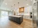 Gourmet kitchen with a large island, custom cabinetry, and stainless steel appliances, perfect for culinary enthusiasts at 102 Pecan Cove Ln, Weddington, NC 28104