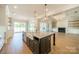 Gorgeous kitchen island with farmhouse sink, marble countertops, and pendant lighting at 102 Pecan Cove Ln, Weddington, NC 28104