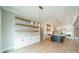 Bright, modern kitchen with a view of the floating shelves, large island, stainless appliances and open floor plan at 102 Pecan Cove Ln, Weddington, NC 28104