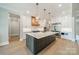 Well-appointed kitchen featuring a spacious island, high-end appliances, and stylish cabinetry, designed for functionality and elegance at 102 Pecan Cove Ln, Weddington, NC 28104