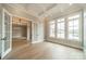 Bright room with coffered ceilings, hardwood floors, three large windows, and adjacent dining space at 102 Pecan Cove Ln, Weddington, NC 28104