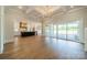 Spacious living area with large sliding glass doors and open-plan kitchen featuring custom island at 102 Pecan Cove Ln, Weddington, NC 28104