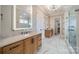 Elegant bathroom with marble floors, double vanity, and a large glass enclosed walk-in shower at 102 Pecan Cove Ln, Weddington, NC 28104