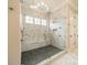 Luxurious walk-in shower with black tiled floor, marble walls, and dual shower heads at 102 Pecan Cove Ln, Weddington, NC 28104