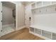 Entryway mudroom with a bench, storage cubbies, and a view into the laundry room at 102 Pecan Cove Ln, Weddington, NC 28104