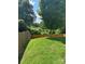 Backyard view featuring a lush green lawn, wooden fence and mature trees at 1021 Joselynn Dr, Gastonia, NC 28054