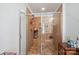 Tiled shower with glass door, tile floor, and built in shelving at 1021 Joselynn Dr, Gastonia, NC 28054