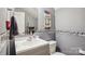 Powder room featuring a framed mirror, vanity, and toilet with decorative floral accents at 1021 Joselynn Dr, Gastonia, NC 28054