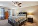 Comfortable primary bedroom with a ceiling fan, large bed, and ample natural light at 1021 Joselynn Dr, Gastonia, NC 28054