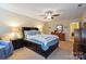 Comfortable primary bedroom with a ceiling fan, large bed, and dresser at 1021 Joselynn Dr, Gastonia, NC 28054