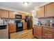 Kitchen featuring wood cabinets, black appliances, and durable countertops at 1021 Joselynn Dr, Gastonia, NC 28054
