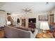 Inviting living room with comfortable sofa, ceiling fan, and neutral color scheme at 1021 Joselynn Dr, Gastonia, NC 28054