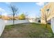 Large fenced backyard with a well-maintained lawn and mature trees, perfect for outdoor activities at 1065 Ellis Pond Dr, Rock Hill, SC 29730