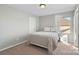 Cozy bedroom with a full-sized bed, carpeted floor and a white wicker nightstand next to a window at 1065 Ellis Pond Dr, Rock Hill, SC 29730
