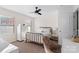 Bright bedroom featuring a ceiling fan, a brass bed frame, and natural light from two windows at 1065 Ellis Pond Dr, Rock Hill, SC 29730