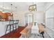 Open concept dining area with wooden table and adjacent to a breakfast bar and modern kitchen at 1065 Ellis Pond Dr, Rock Hill, SC 29730